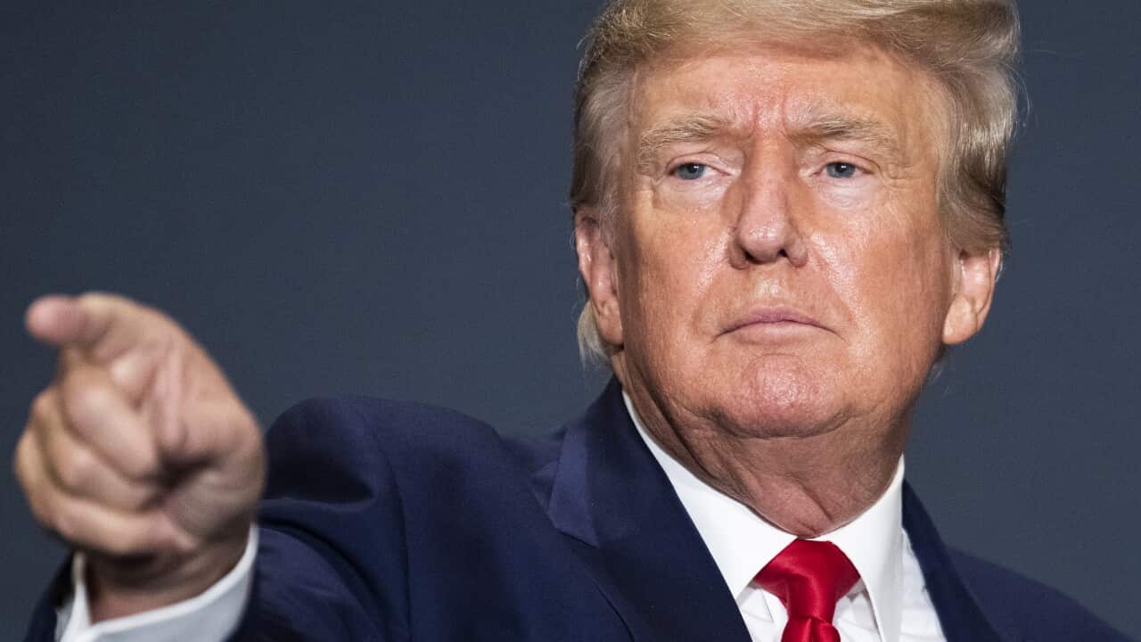 Donald Trump standing and pointing his fingure.