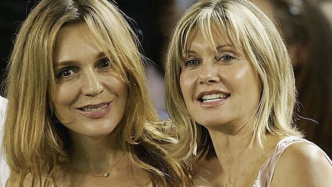 two blonde women smiling together