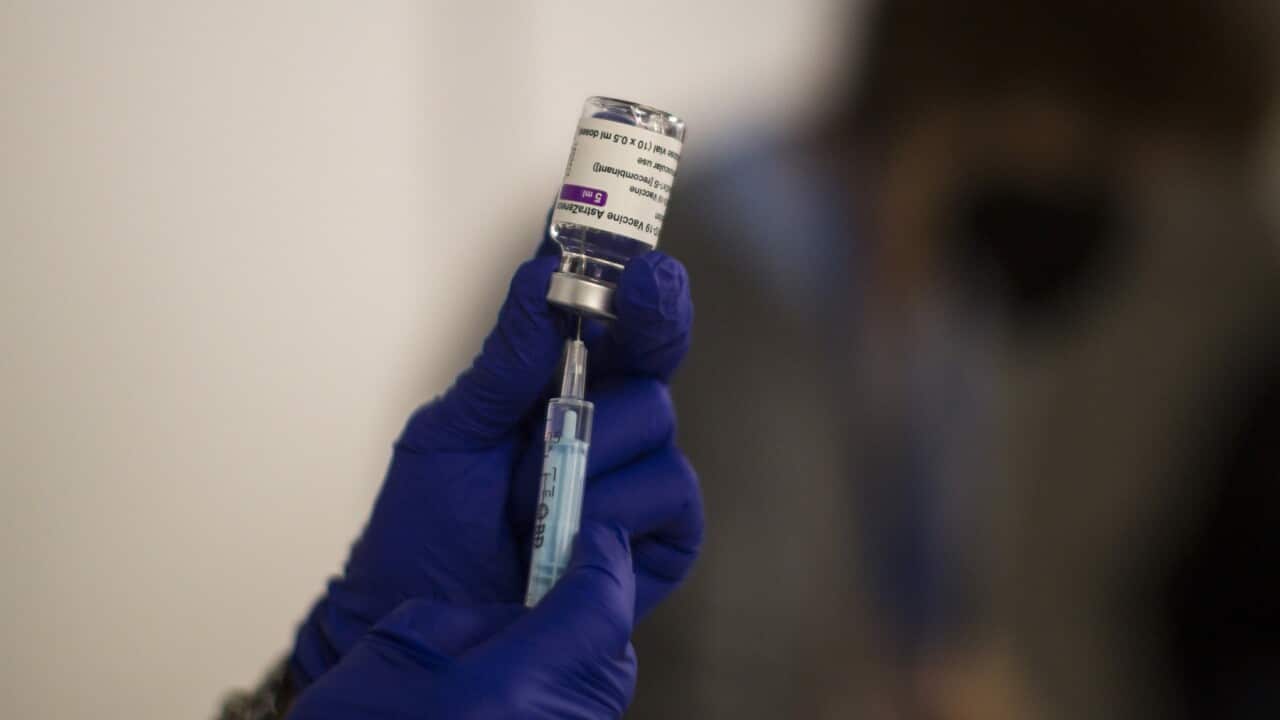 A nurse prepares to administer a dose of AstraZeneca vaccine.