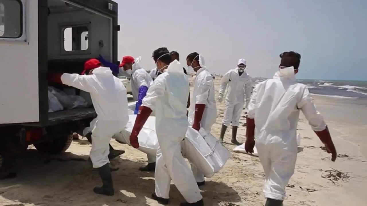 Emergency services remove the body of a victim