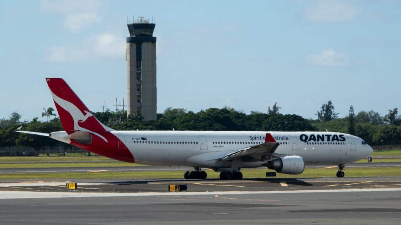 A qantas plane on a runway
