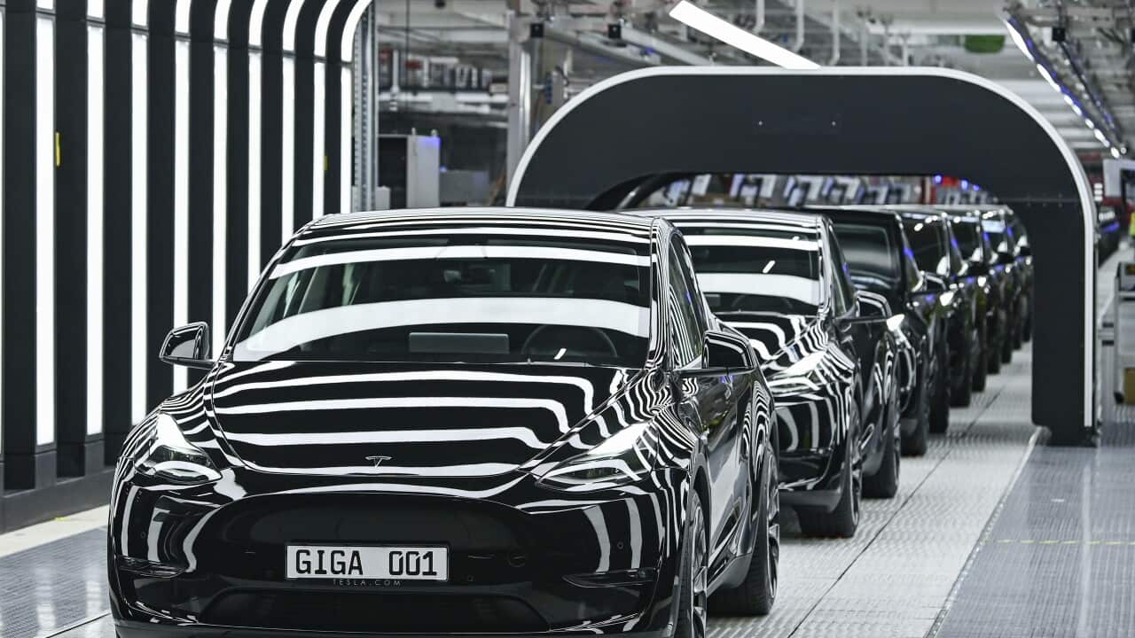 Model Y electric vehicles stand on a conveyor belt at the opening of the Tesla factory in Berlin Brandenburg in Gruenheide, Germany, Tuesday, March 22, 2022. The first European factory in Gruenheide, designed for 500,000 vehicles per year, is an important