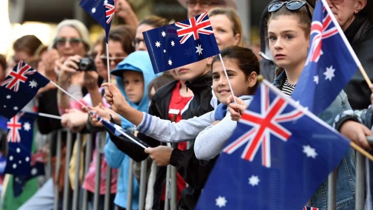 Spectators watch on during the Anzac Day march in Sydney, Monday, April 25, 2016. This year marks the 100th anniversary of the first Anzac Day service. (AAP Image/Dan Himbrechts) NO ARCHIVING