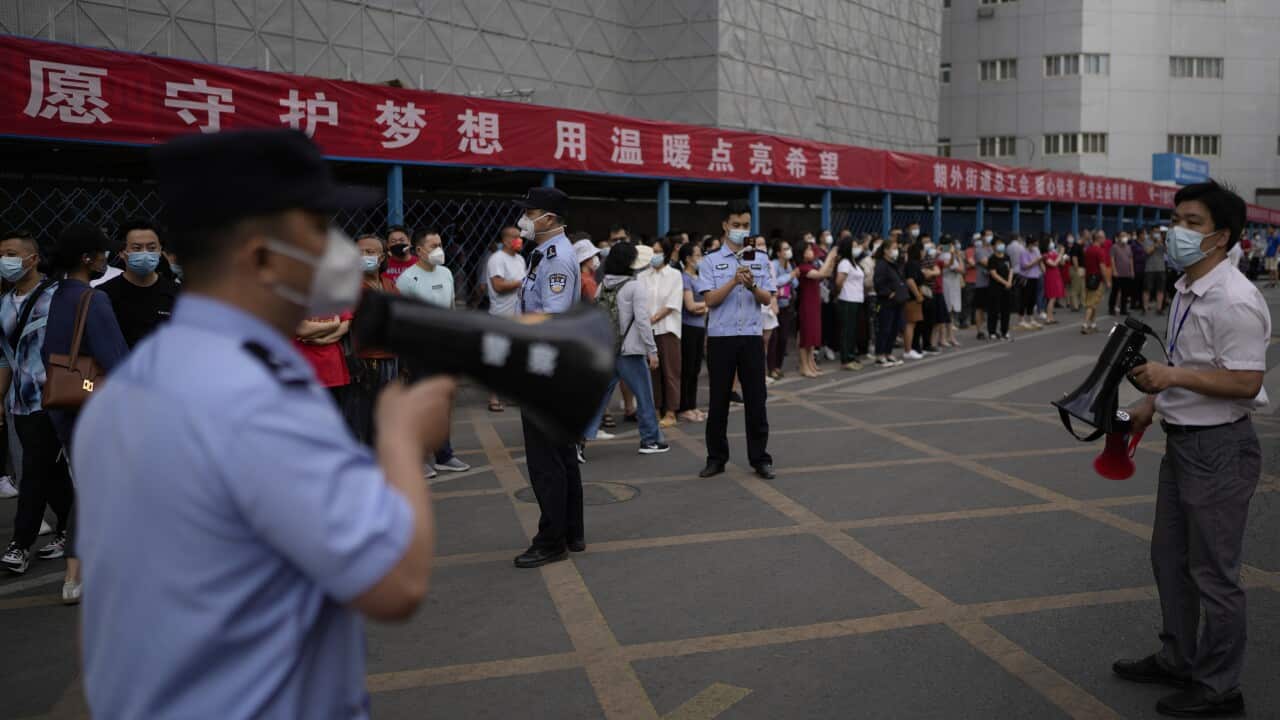 A man speaks through a loudspeaker.