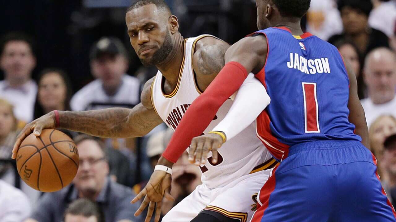 Cavaliers' LeBron James (23) drives past Pistons' Reggie Jackson