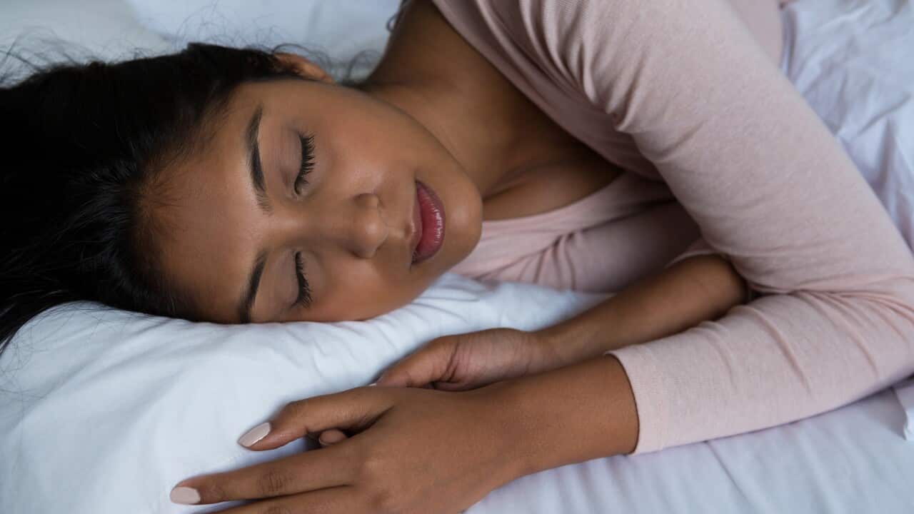 Young woman sleeping on bed
