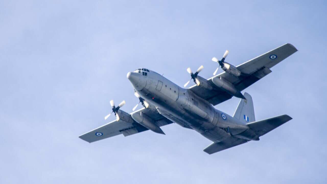 A HAF C-130H ariplane passes overhead. Hellenic Air Force