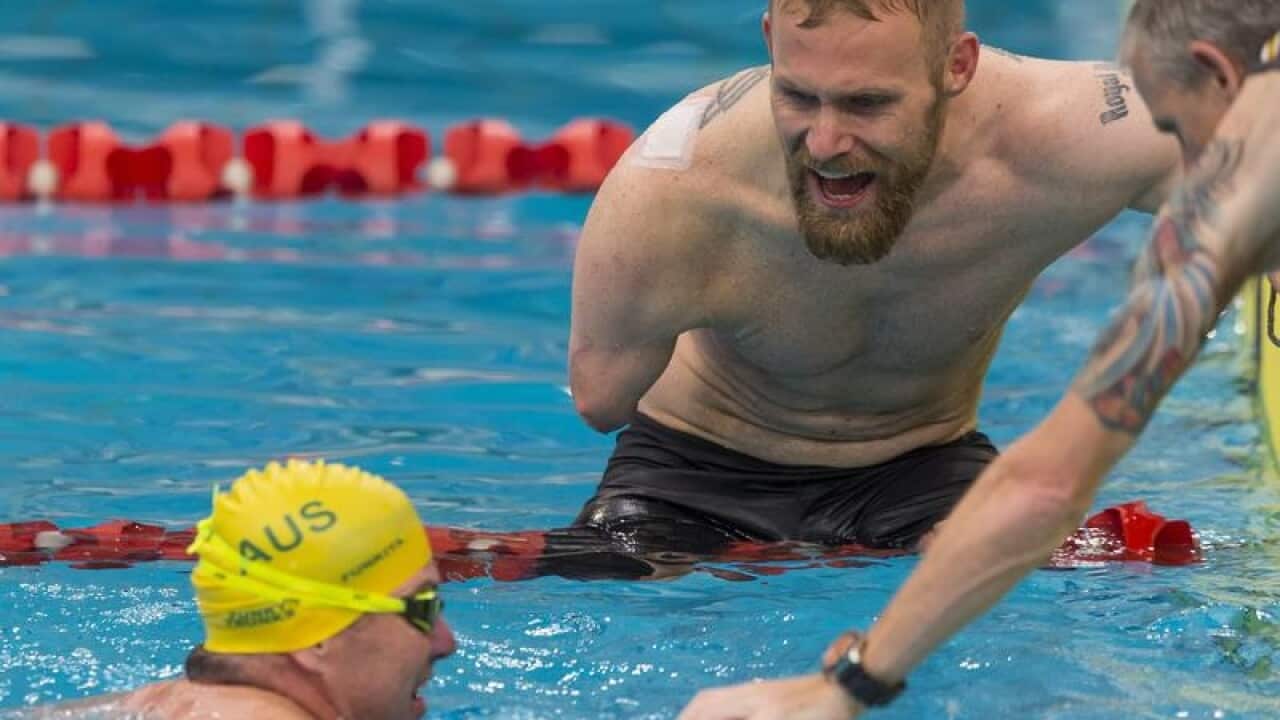 Mark Ormrod of the UK encourages Australia's Garry Robinson.