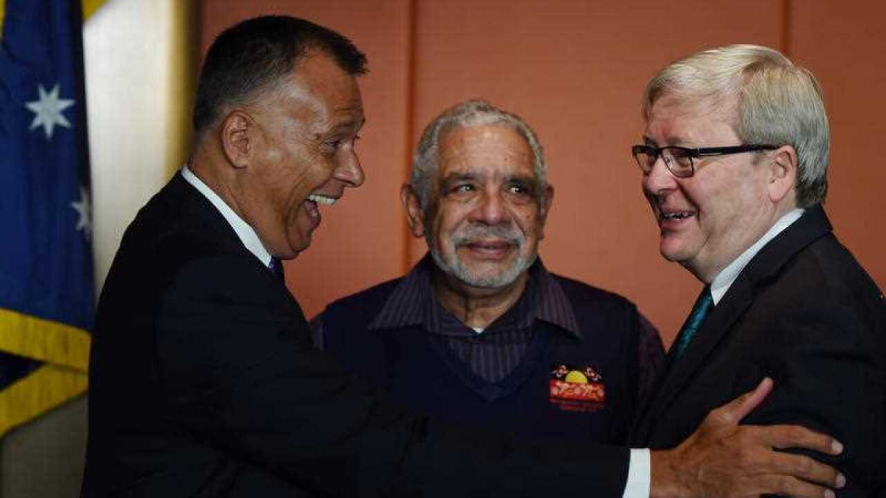 Former prime minister Kevin Rudd (right) speaking with journalist Stan Grant (left) and aboriginal elder Uncle Allen Madden (centre) at The National Apology anniversary breakfast at New South Wales Parliament House in Sydney, Friday, Feb. 12, 2016.
