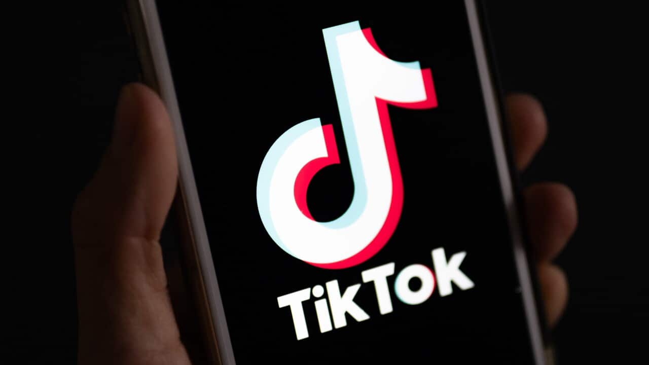 TikTok logo is displayed on a phone.