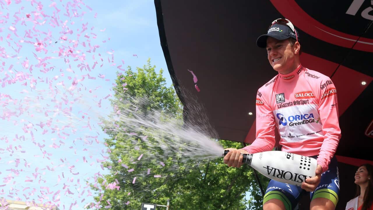 Australian rider Simon Clarke celebrates the pink jersey of the overall leader on the podium of the 4th stage of the Giro d'Italia, Tour of Italy,