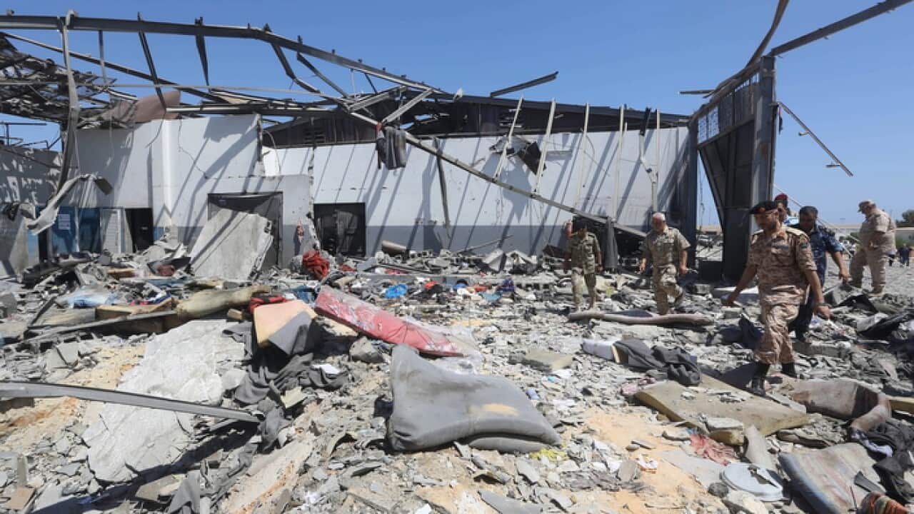People search the rubble of the destroyed Tajoura detention centre