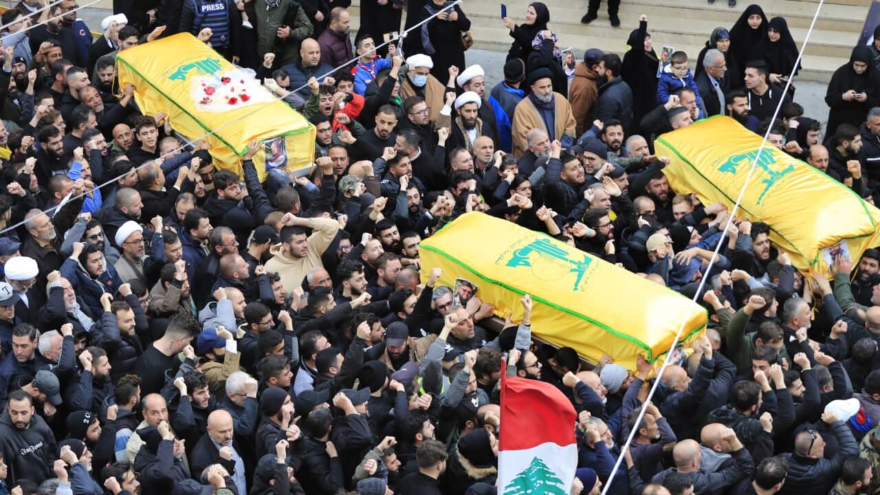 Mourners carry the coffins of Ibrahim and Ali Bazzi and Ibrahim's wife Shorouq Hammoud