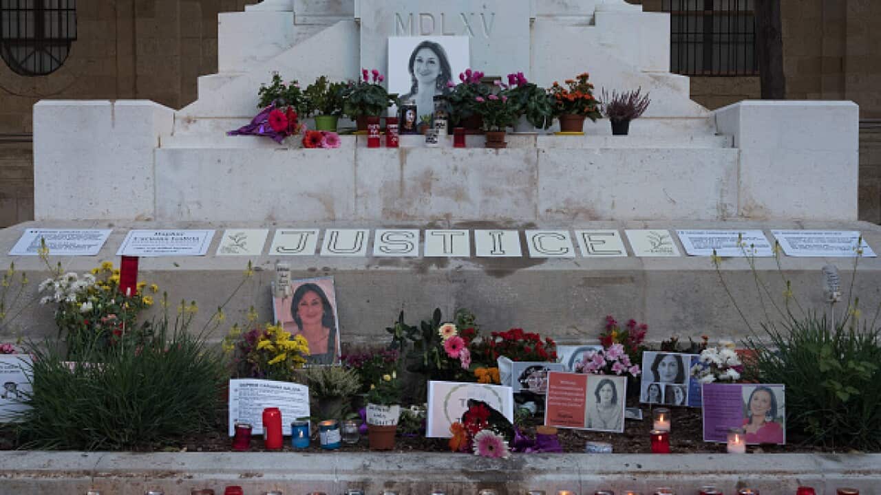 Flowers and candles at a memorial for murdered journalist Daphne Caruana Galizia memorial in Malta