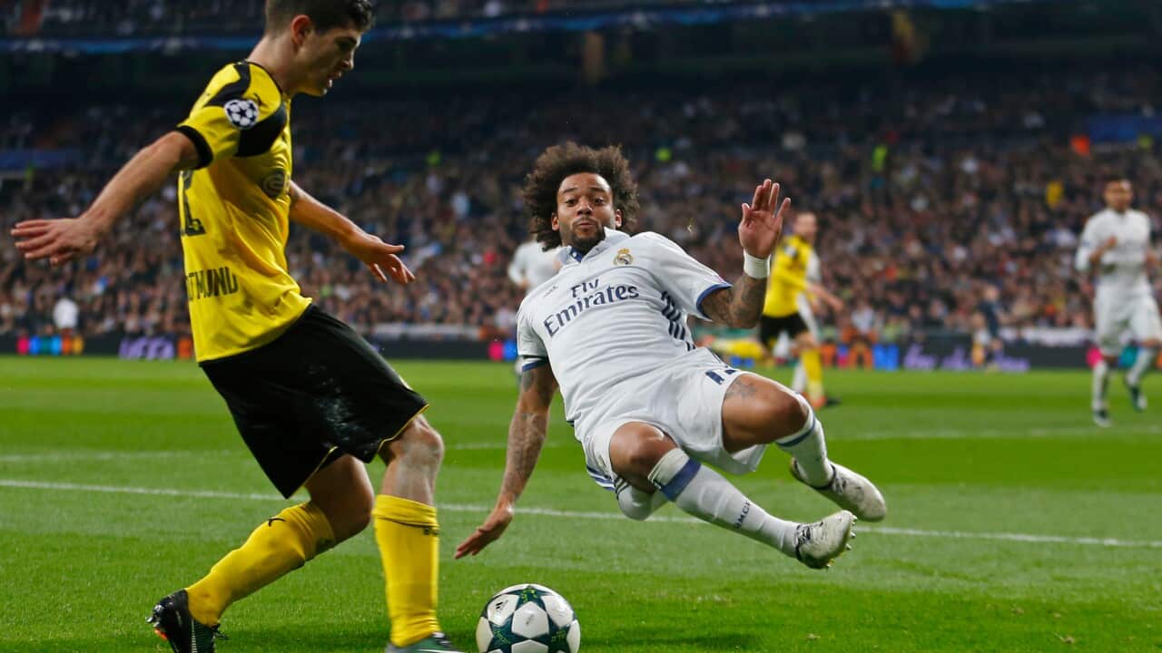 Real Madrid's Marcelo slides in for a tackle in the Champions League