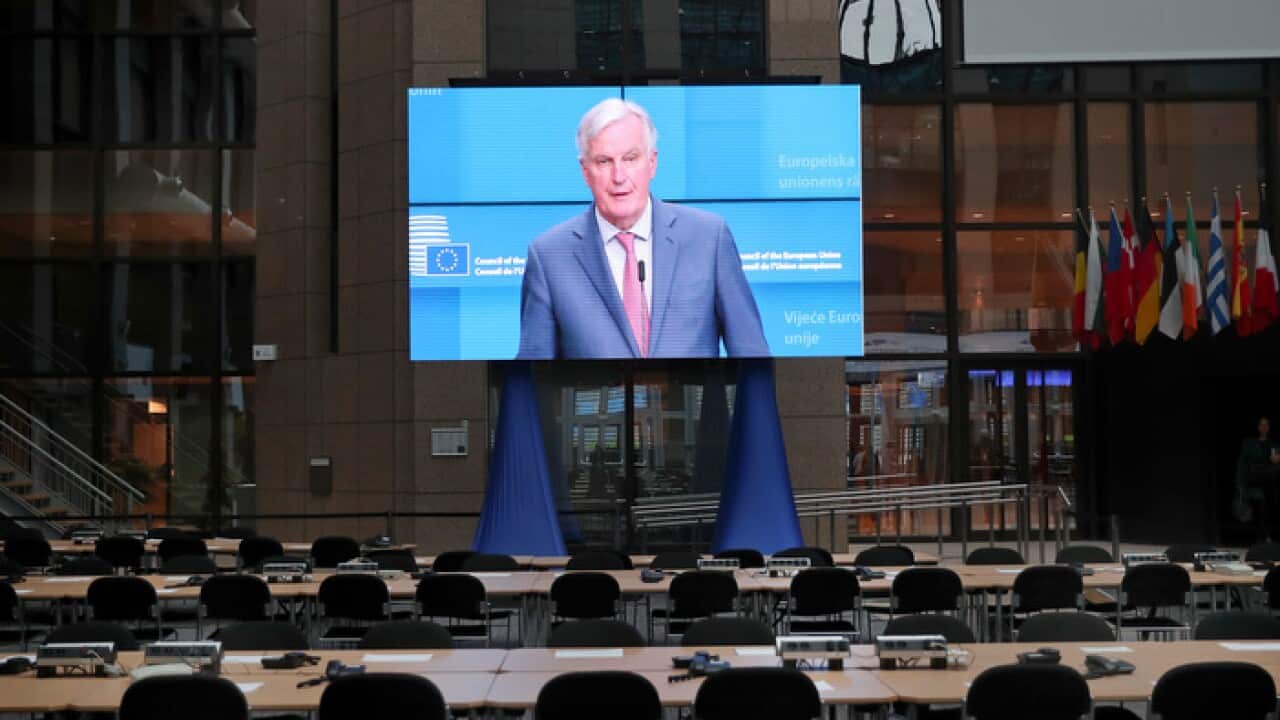 A big screen placed in the main press EU summit hall displays European Union Brexit negotiator Michel Barnier