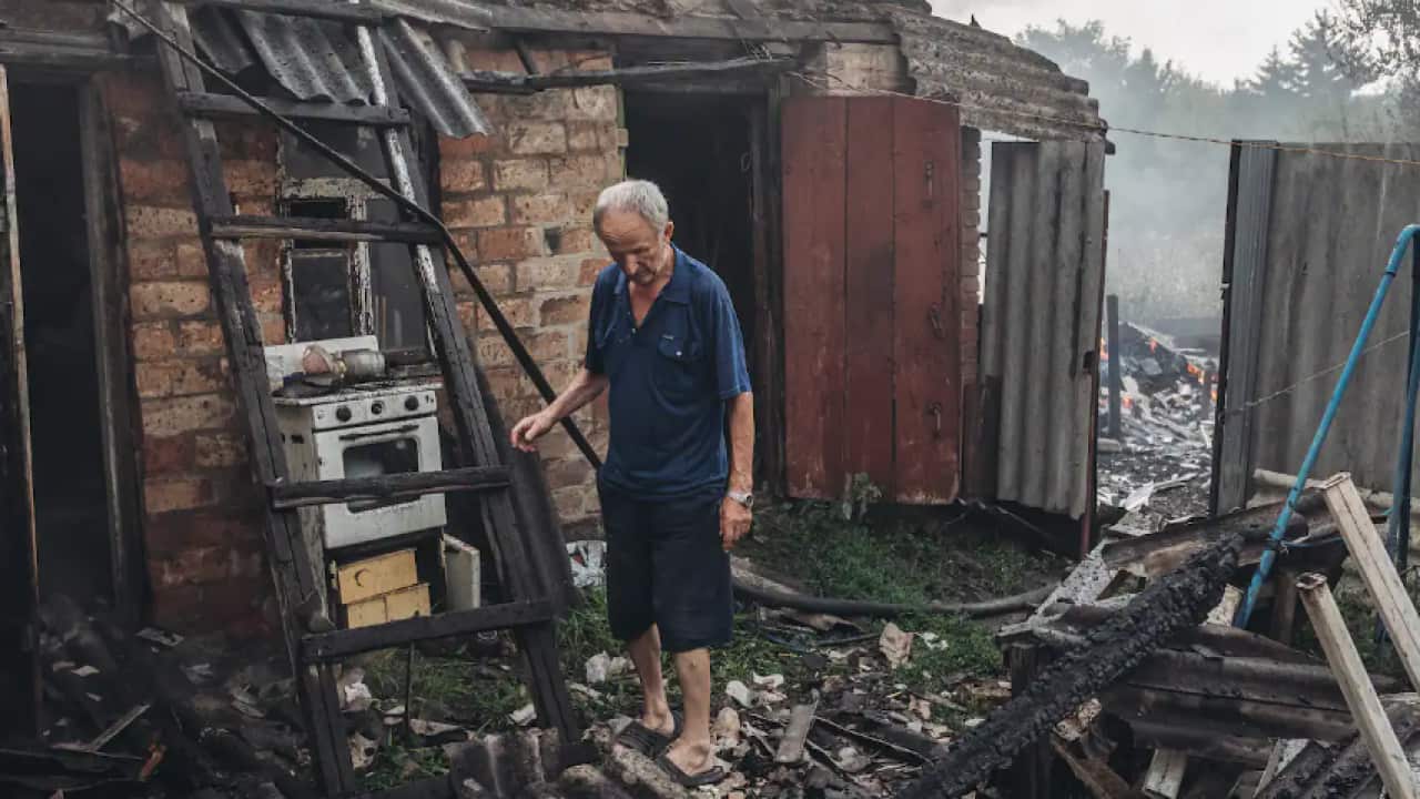 A Ukrainian man is seen examining his destroyed house, which was burned to ashes in the fire caused by the shelling, as the Russia-Ukraine war continues in Opytne, Donetsk Oblast, Ukraine on 1 August, 2022