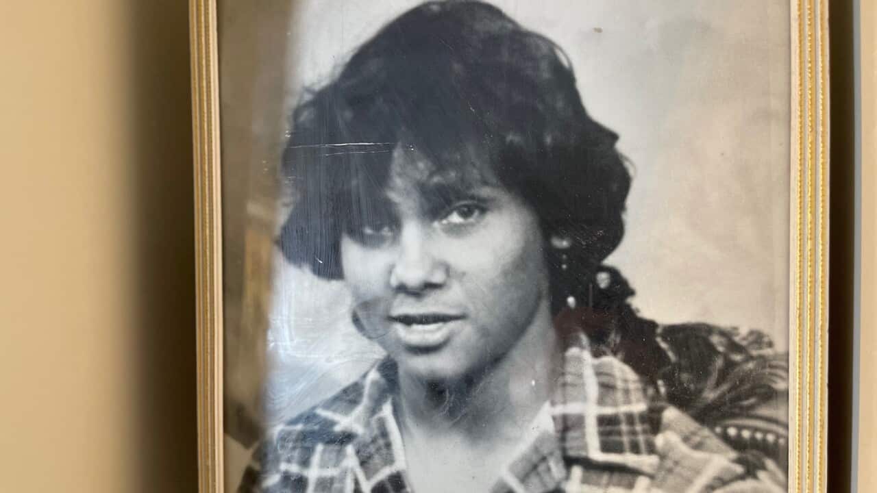 A photo of a framed black and white photo, showing 17-year-old Gomeroi teenager Mark Haines. He is looking direct to camera and is wearing a chequered shirt.