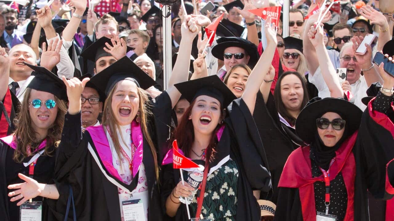 Students from RMIT celebrating after their graduation