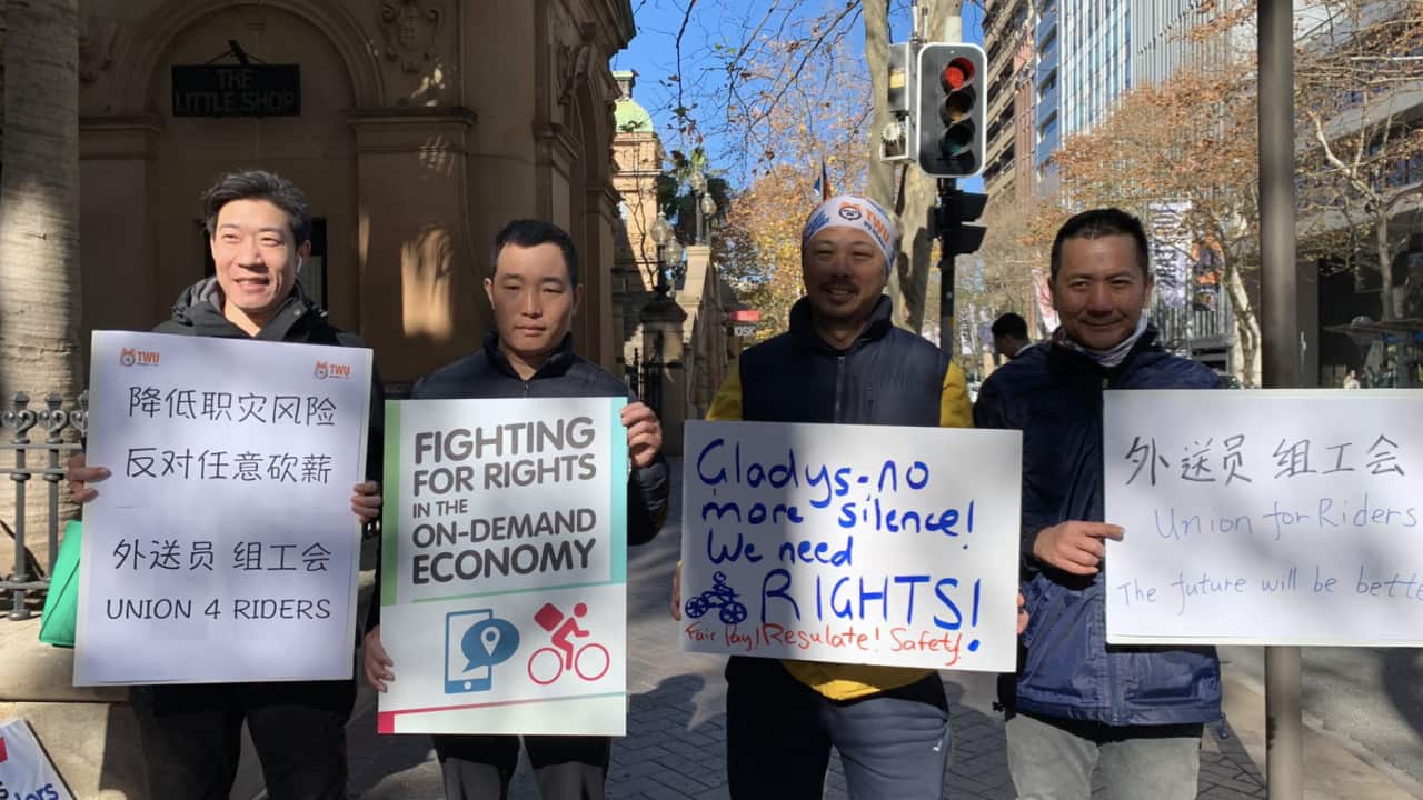 Food delivery riders protest the government's proposed new safety laws outside NSW Parliament.