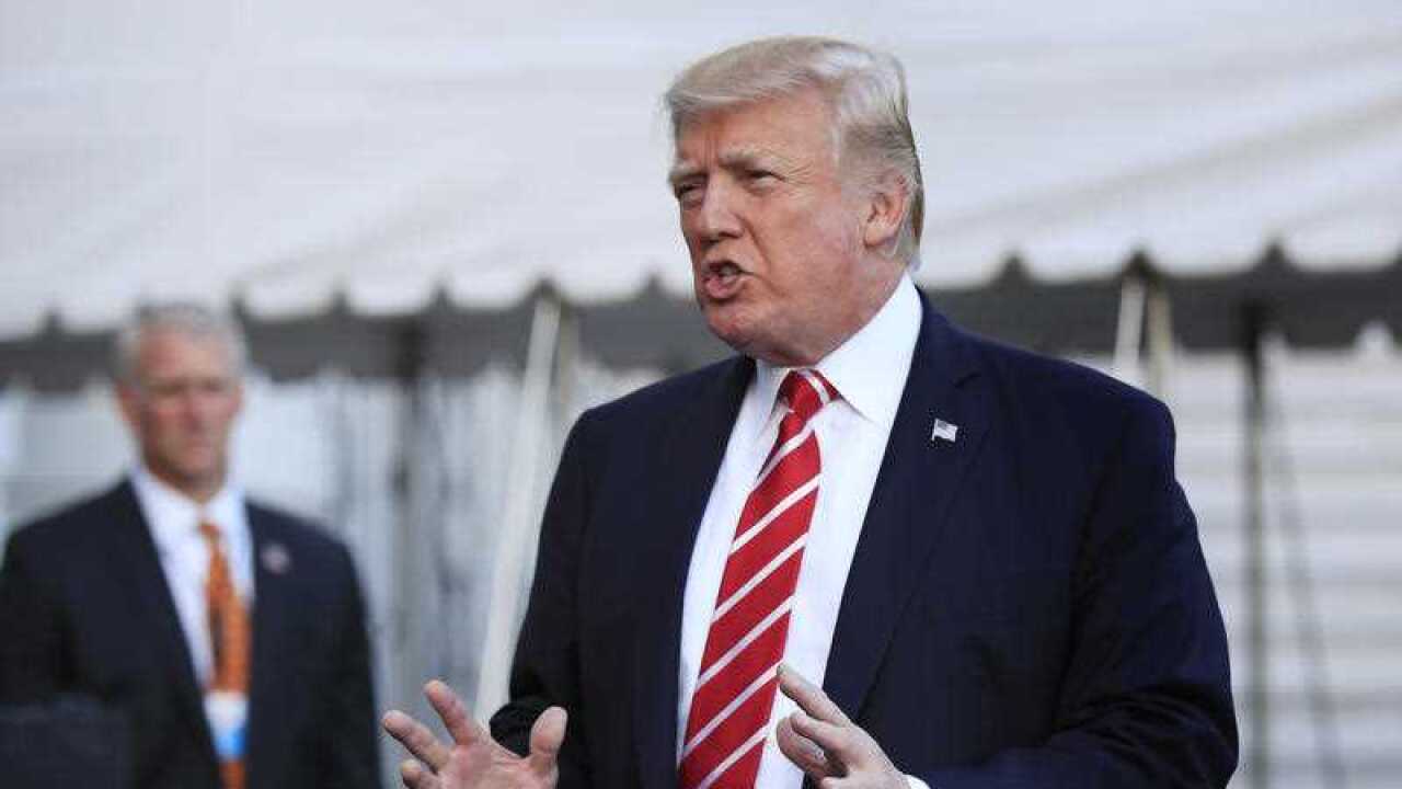 In this Oct. 7, 2017, file photo, President Donald Trump speaks to reporters before leaving the White House in Washington.