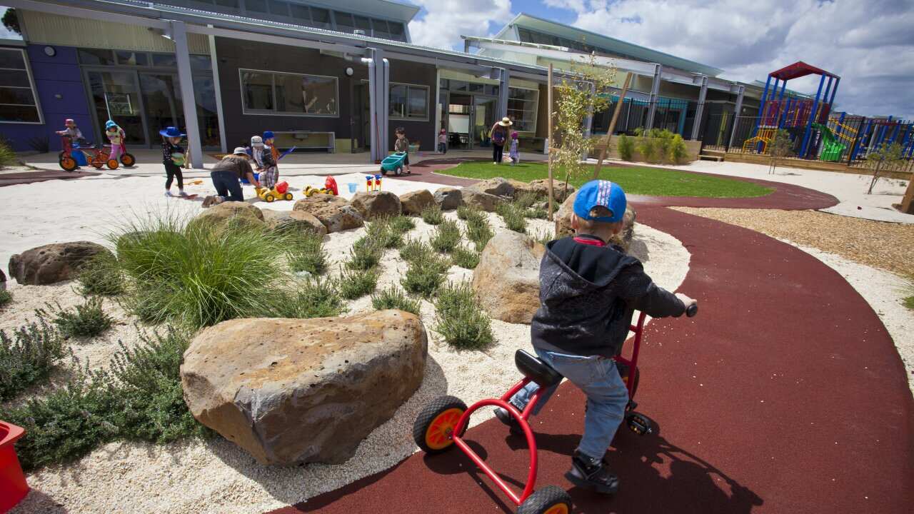Preschool children playing outdoors.