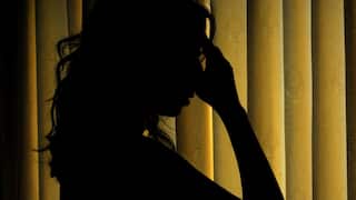 A woman poses for a photograph illustrating mental illness