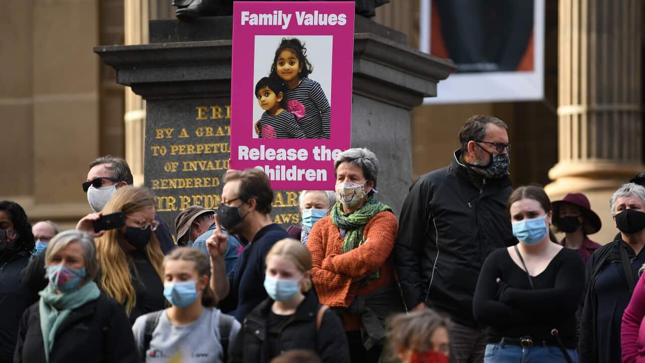 Protesters are seen during a rally at the State Library of Victoria in Melbourne, Saturday, June 19, 2021. A rally is being held in Melbourne against the federal government's decision not to allow the Murugappan family to return to Biloela in central Quee