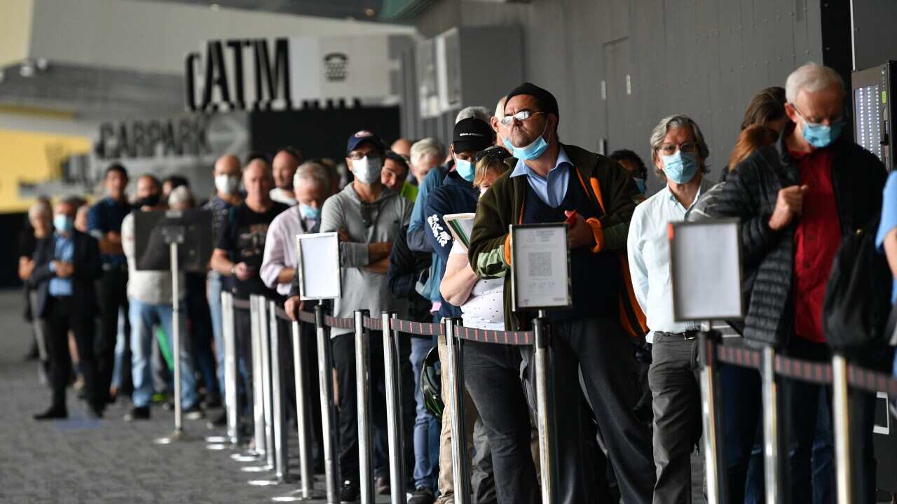 People are seen lining up for their COVID-19 vaccination at the Melbourne Convention and Exhibition Centre on Monday, 3 May, 2021.