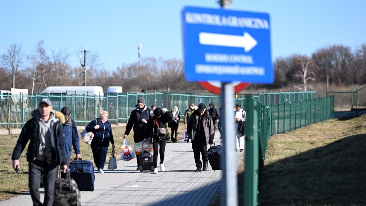 People walk near the Polish-Ukrainian border crossing in Medyka, Poland 24 February 2022.