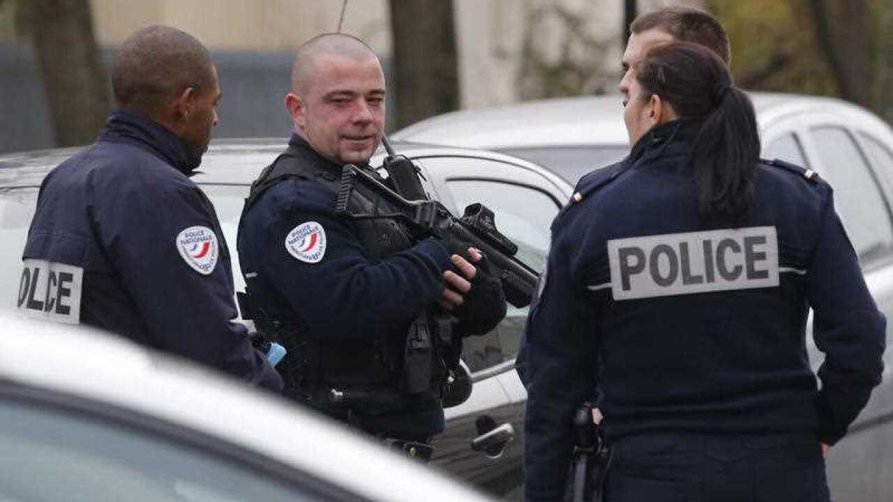 Police officers patrol near a pre-school, after a masked assailant with a box-cutter and scissors who mentioned the Islamic State group attacked a teacher, Monday, Dec.14, 2015 in Paris suburb Aubervilliers. The assailant remains at large, and the motive