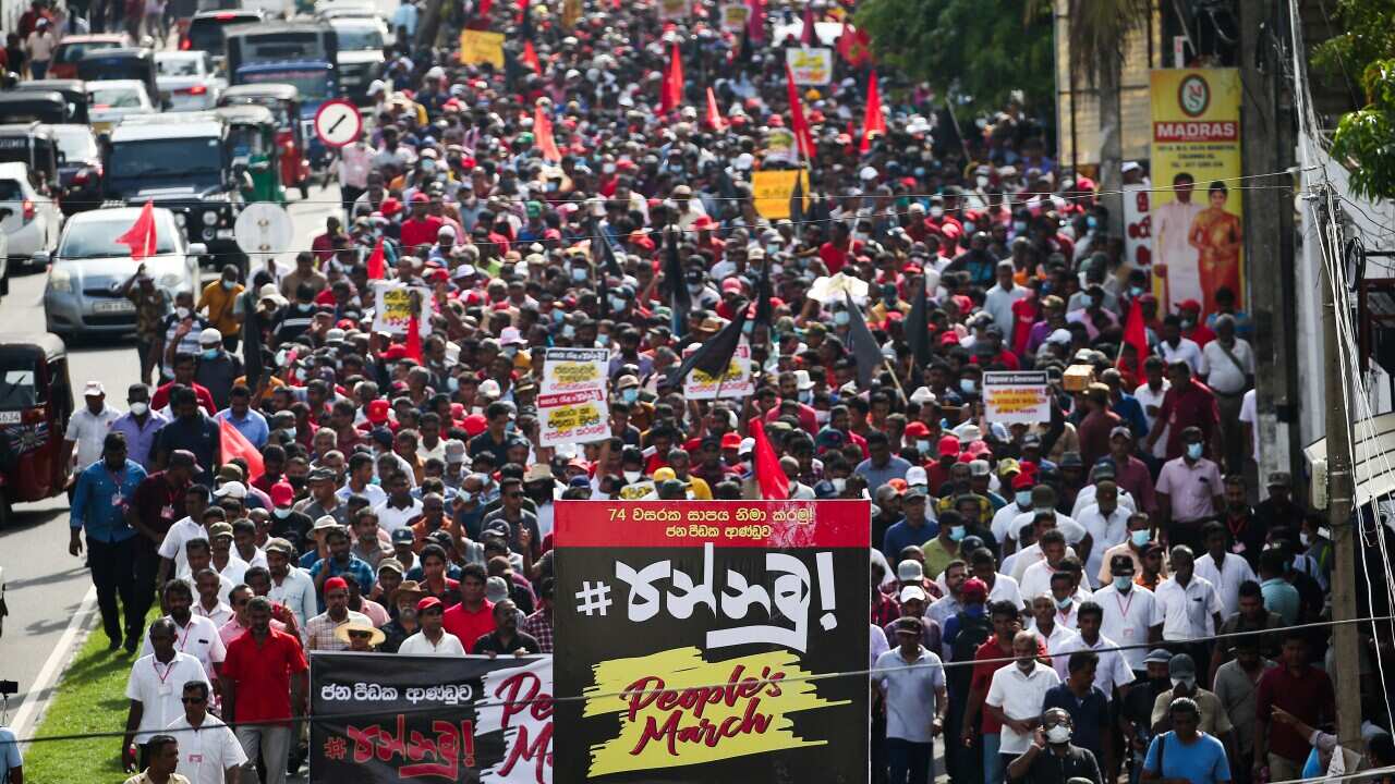 A crowd of protesters marching down a street.