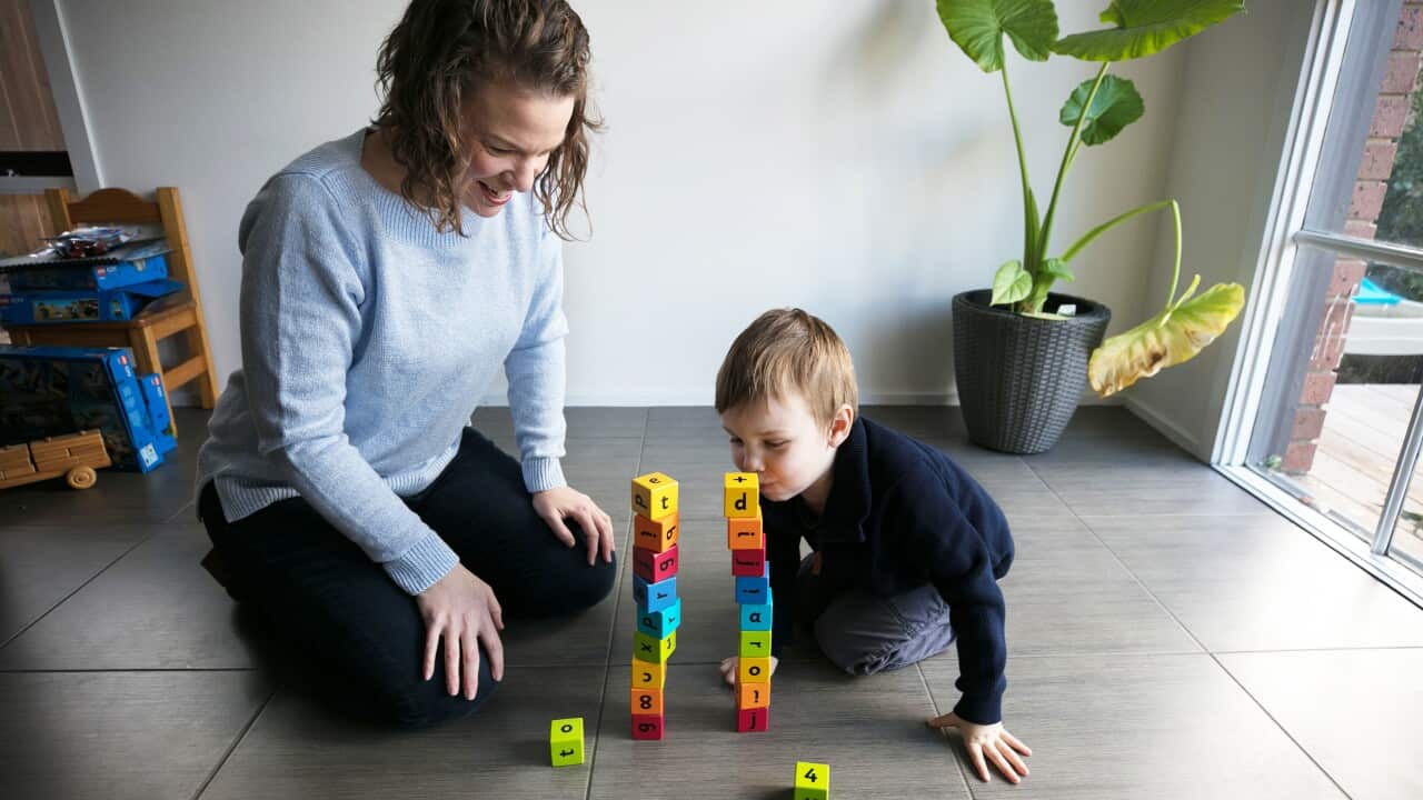 Pip Reid stacking colourful blocks with her 3 year old son