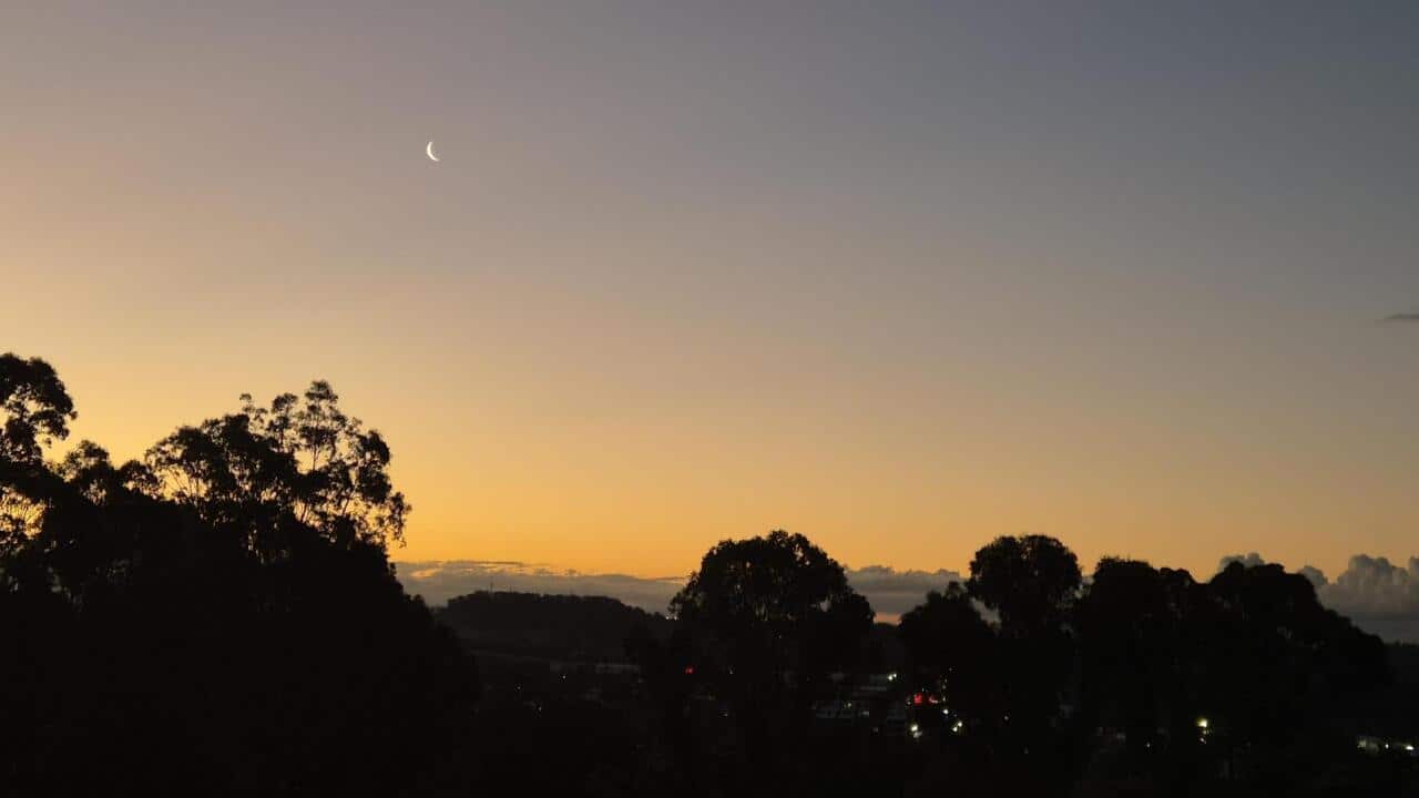 General view of the sunset and crescent moon from Sydney.
