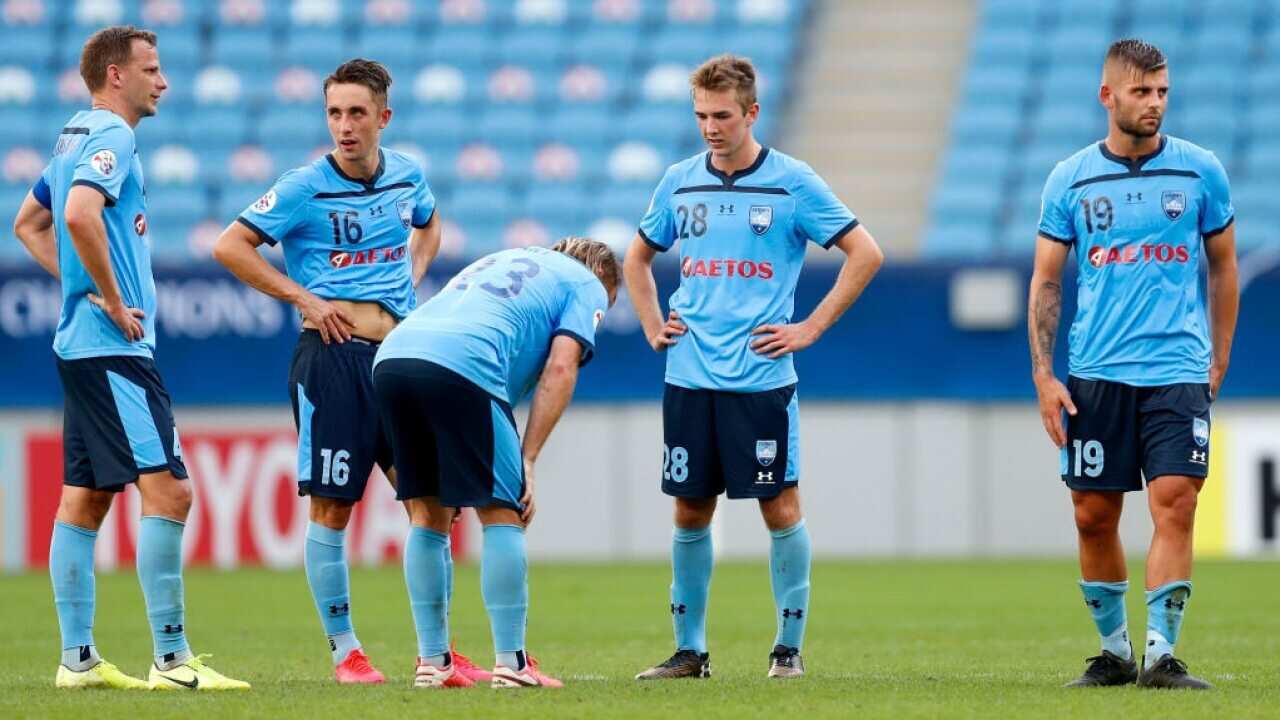 Sydney FC players react after an AFC Champions League match