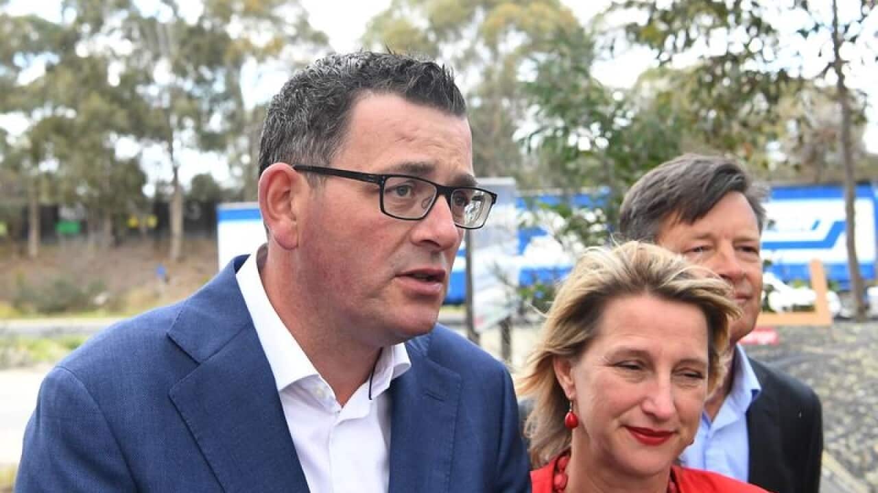 Premier Daniel Andrews next to the M80 road.