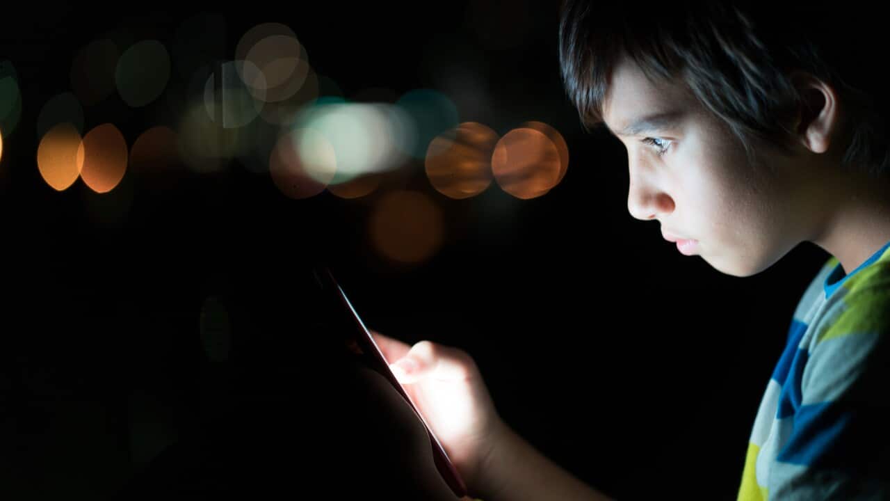 Kid with a mobile phone/cpmputer