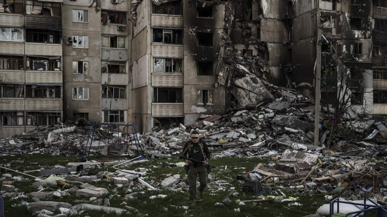 A Ukrainian serviceman walks amid the rubble of a building heavily damaged by multiple Russian bombardments near a frontline in Kharkiv, Ukraine, Monday, April 25, 2022. (AP Photo/Felipe Dana)