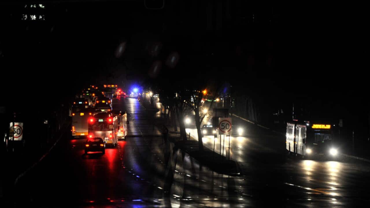 Traffic in total darkness around the CBD in Adelaide after the power network stopped working on Wednesday September, 28, 2016. (AAP Image/David Mariuz) NO ARCHIVING