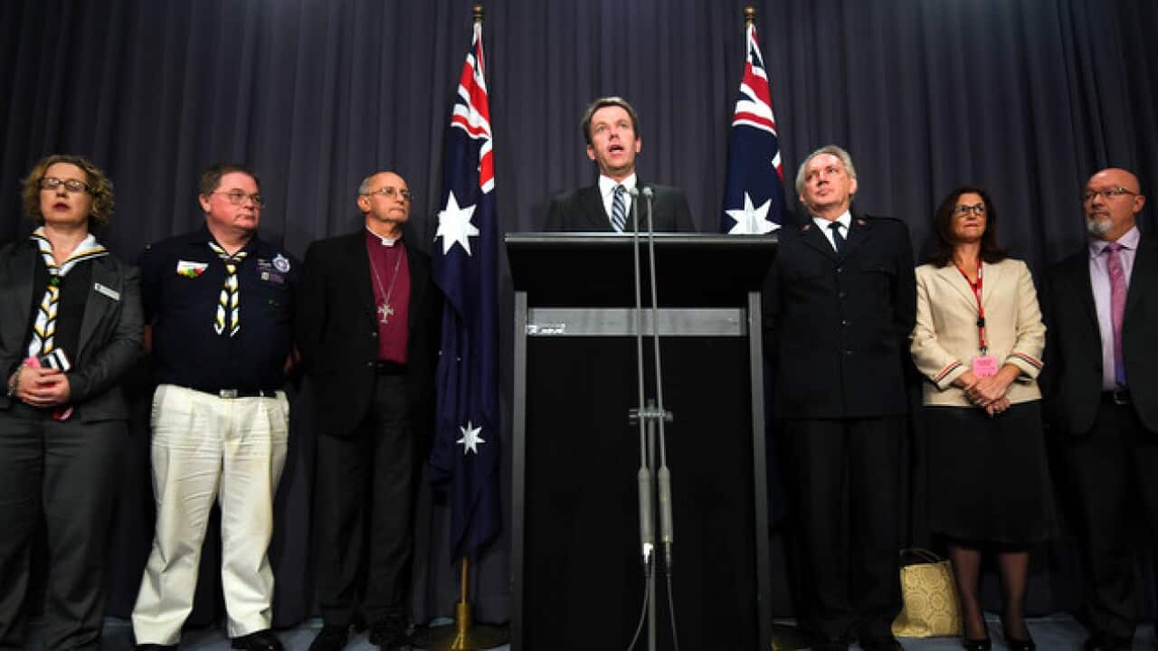 Social Services Minister Dan Tehan and representatives of the Anglican Church, the Salvation Army, the Scouts and the YMCA