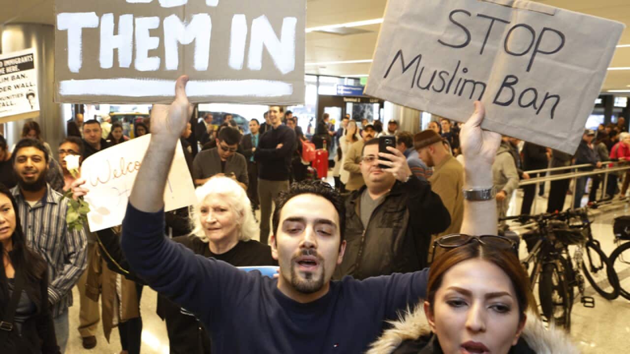 Supporters cheer at the Los Angeles International Airport