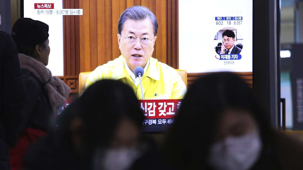 A TV screen shows South Korean President Moon Jae-in's speech during a news program at the Seoul Railway Station in Seoul, South Korea, Sunday, 23 February