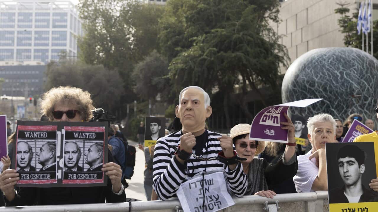 A protester dressed in a mask and prisoner uniform during a demonstration outside court.