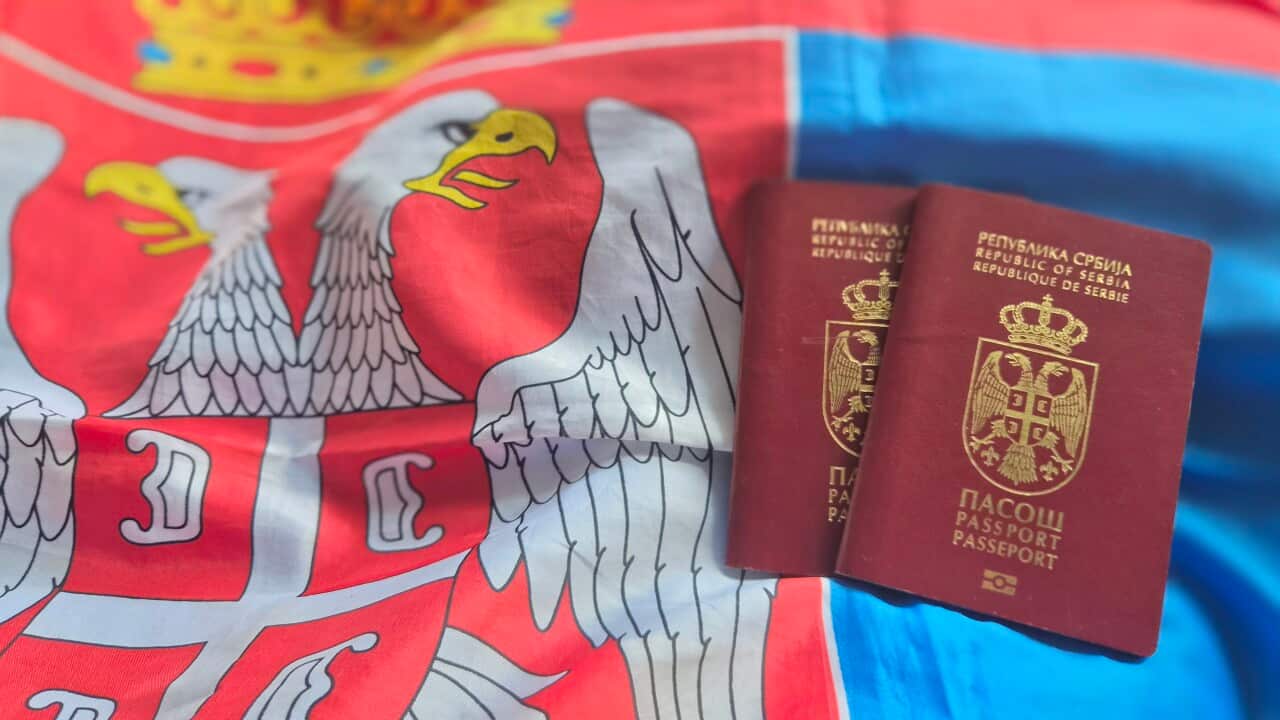 Serbian Passport on the National Flag of the Republic of Serbia