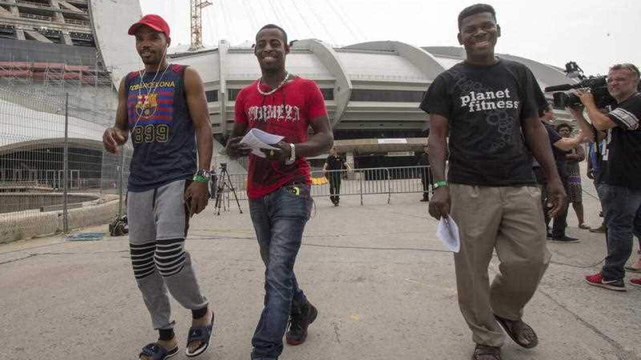 Asylum seekers from Haiti leave Olympic Stadium in Montreal, Canada.
