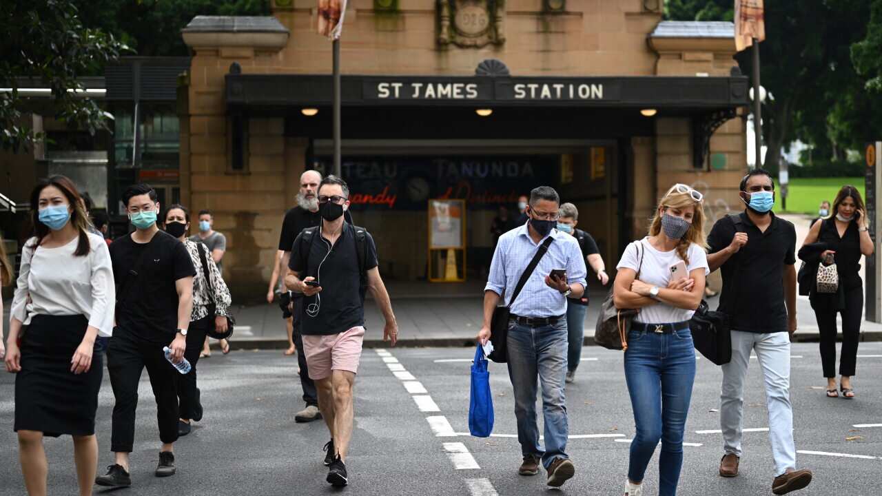 Commuters wearing face masks exit St James Station in Sydney's CBD on Monday, January 4, 2021.