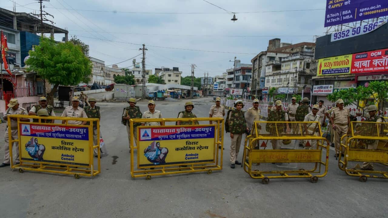 Security personal stand guard in the curfew bound area after the killing of tailor in Udaipur, India 29 June 2022.