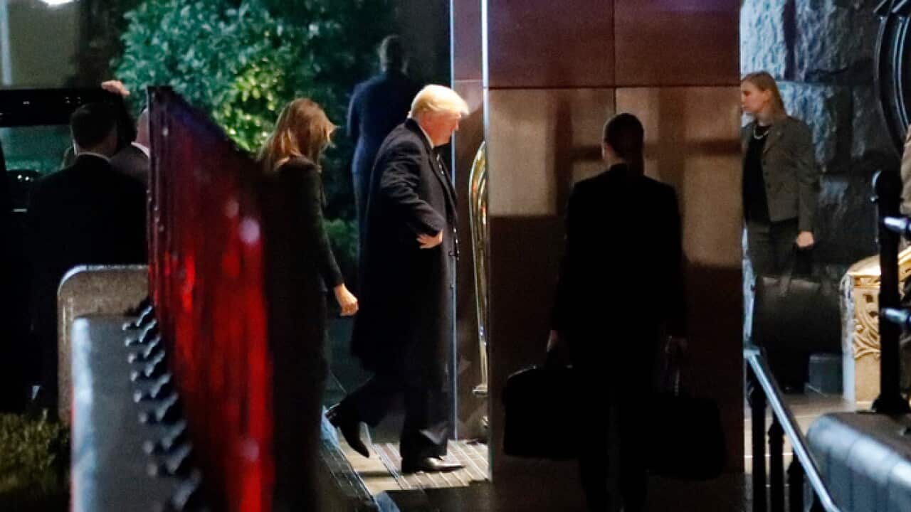 President Donald Trump, second from left, followed by first lady Melania Trump, enters the Trump International Hotel, Saturday, Feb. 10, 2018, in Washington. (AP Photo/Alex Brandon)