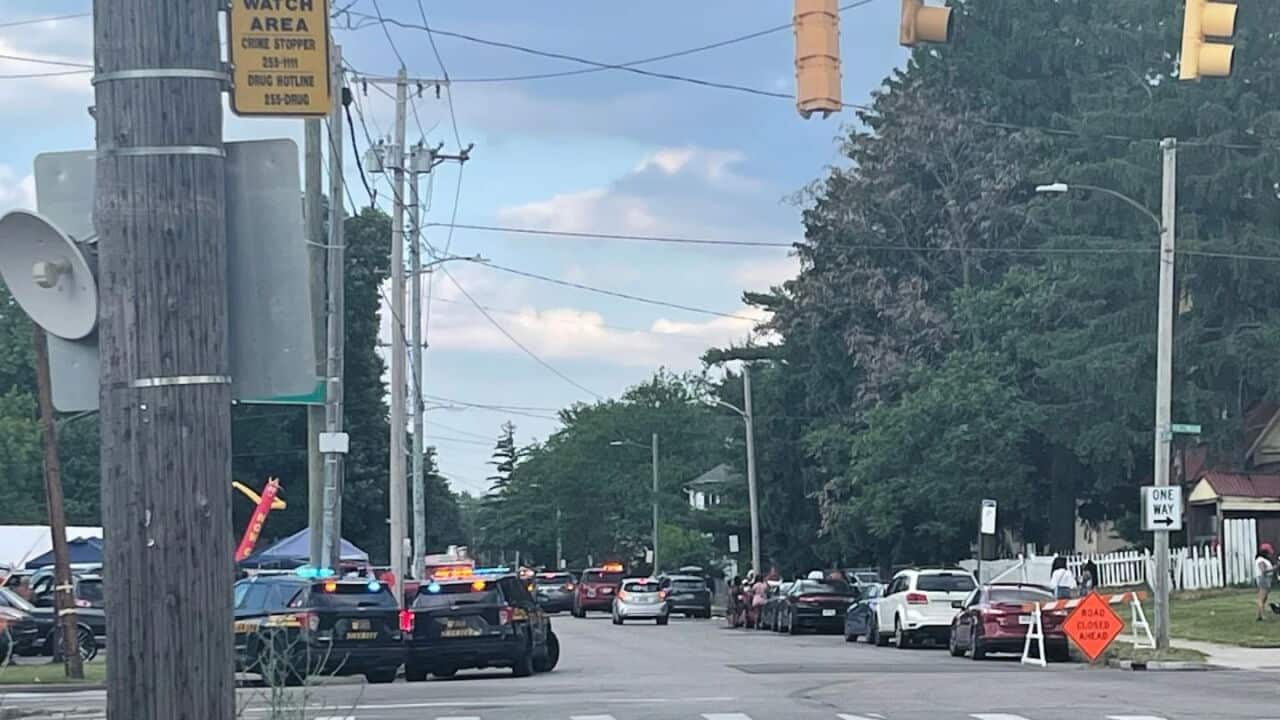 Police cars with their lights on on a suburban street