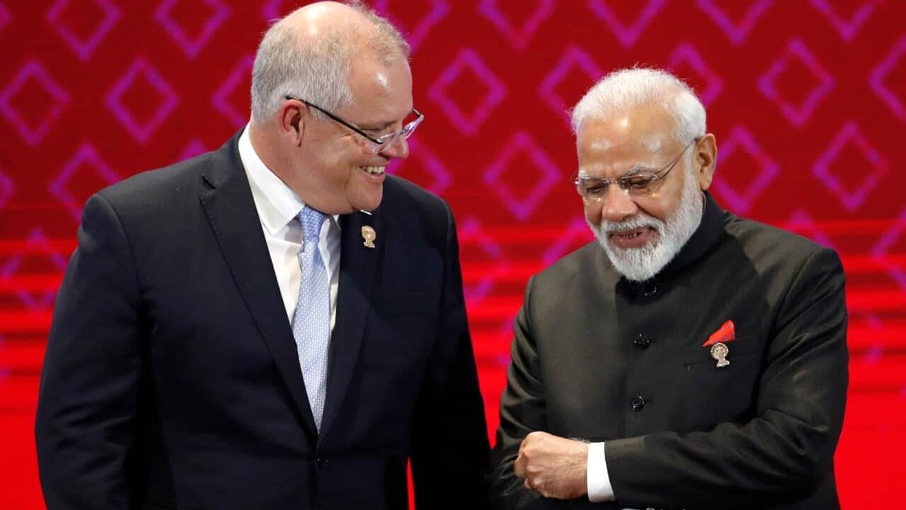 Australia's Prime Minister Scott Morrison (L) chats with India's Prime Minister Narendra Modi (R)